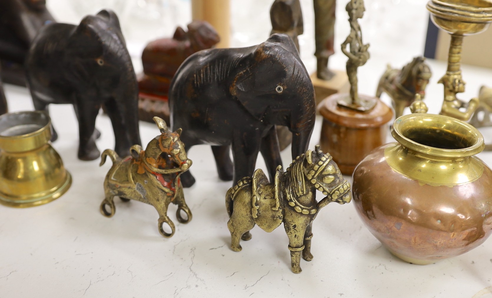 A quantity of Indian carvings and cast brass figures, tallest 20cm